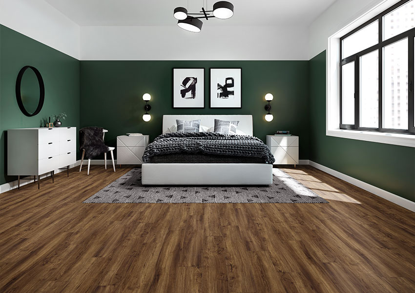 black geometric area rug in bedroom with vinyl plank flooring