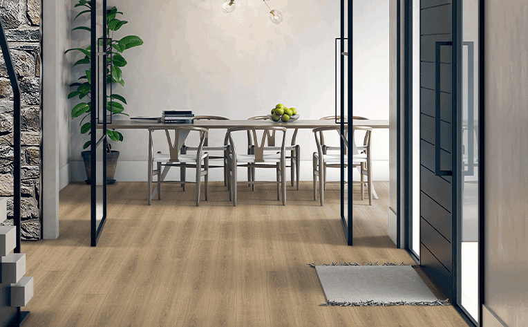 warm toned laminate in entryway with entry mat